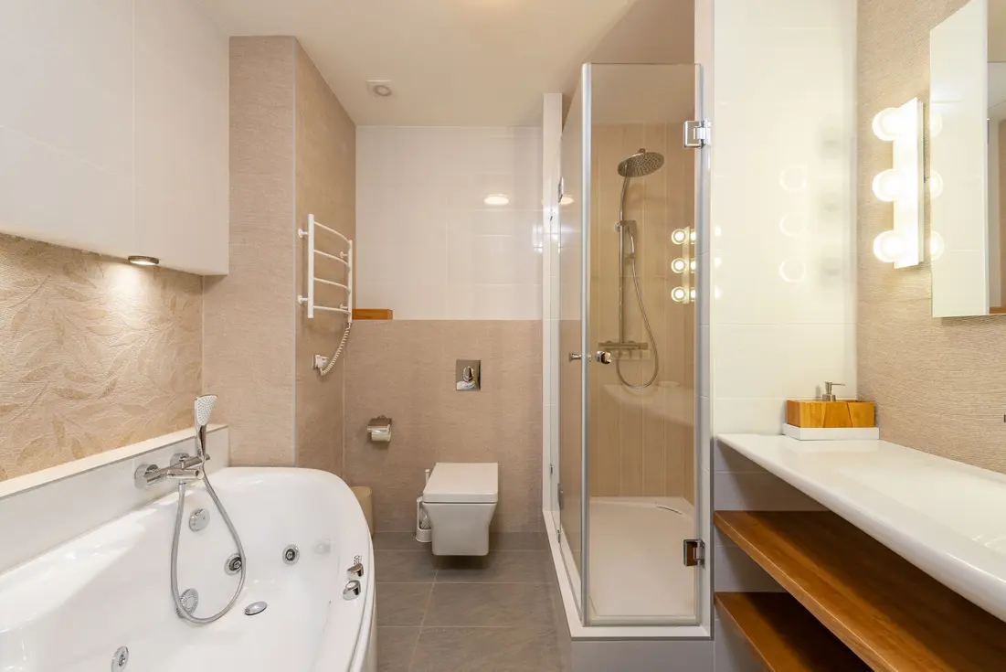 Modern bathroom with a secure towel bar, shower, and jacuzzi bathtub.