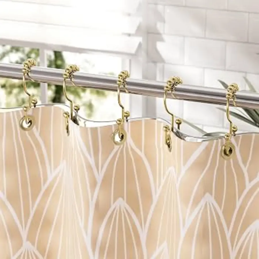 Shower curtain hanging from metal hooks on a rod in a bright bathroom setting.