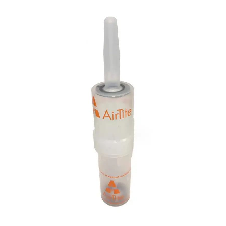 A caulk dispensing tool with a nozzle stored in a transparent container.