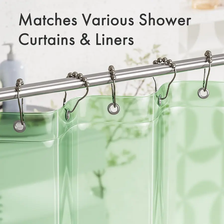 Shower curtain rings hanging on a rod with a slight rust discoloration near the rings.